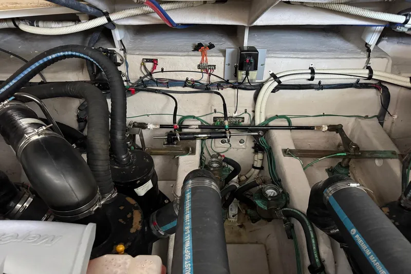 Slide: The Image of Engine room of a 2010 Sea Ray 390 Sundancer with visible hoses and wiring. - 39