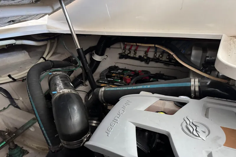 Slide: The Image of Engine compartment of a 2010 Sea Ray 390 Sundancer boat, featuring hoses and mechanical components. - 40