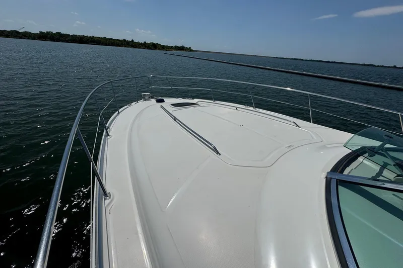 Slide: The Image of 2010 Sea Ray 390 Sundancer yacht on calm waters under clear sky. - 8