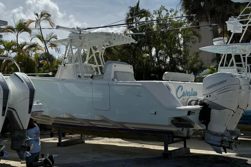The Image of 2022 SeaVee 322z boat with twin Mercury engines, docked outdoors. - 0