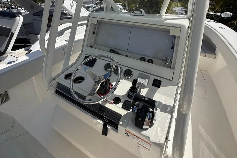 Slide: The Image of 2022 SeaVee 322z boat helm with steering wheel and control panel. - 5
