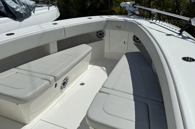 Slide: The Image of 2022 SeaVee 322z boat interior with white cushioned seating and speakers. - 8