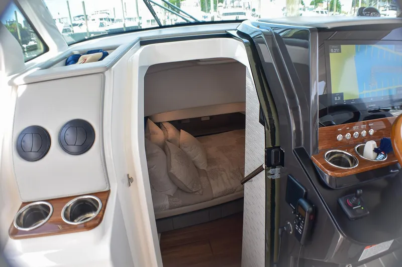 Slide: The Image of 2025 Tiara Yachts 43 LS cabin interior with helm and navigation display. - 13