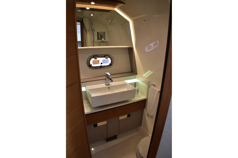 Slide: The Image of Luxurious bathroom interior of 2025 Tiara Yachts 43 LS, featuring modern sink and lighting. - 15
