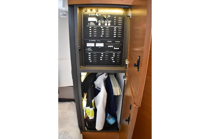 Slide: The Image of Electrical panel and storage in 2025 Tiara Yachts 43 LS cabin interior. - 16