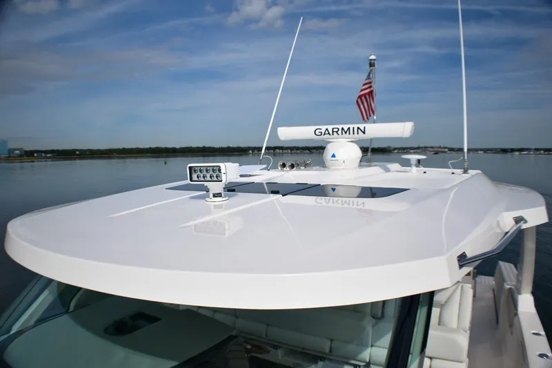 Slide: The Image of 2025 Tiara Yachts 43 LS with Garmin equipment on calm water. - 19