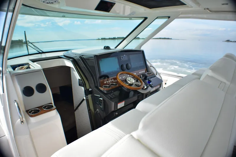 Slide: The Image of 2025 Tiara Yachts 43 LS helm with modern controls and luxurious seating. - 21