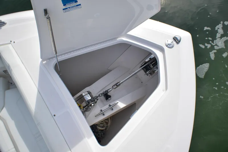 Slide: The Image of Open anchor locker on 2025 Tiara Yachts 43 LS, showcasing chain and winch system. - 27