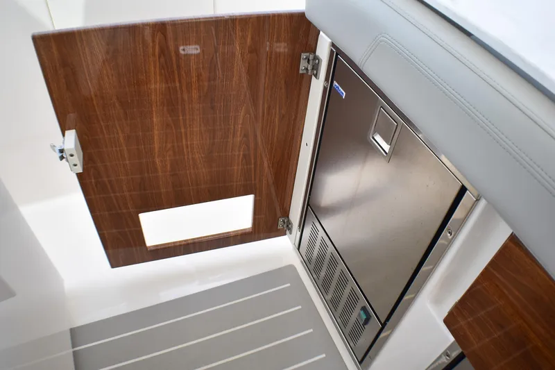 Slide: The Image of 2025 Tiara Yachts 43 LS interior with wood paneling and stainless steel appliance. - 35