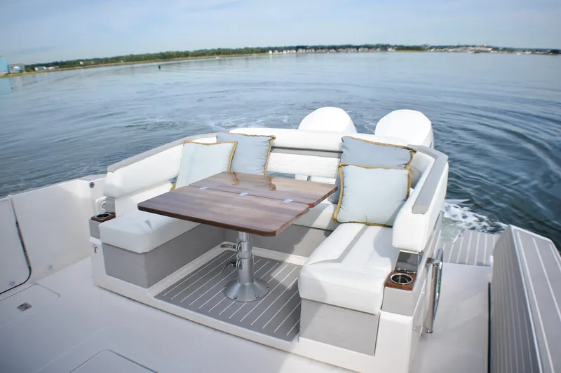 Slide: The Image of Luxurious seating area on 2025 Tiara Yachts 43 LS, featuring elegant cushions and a wooden table. - 40