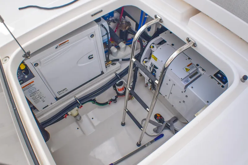 Slide: The Image of Engine compartment of 2025 Tiara Yachts 43 LS, featuring Onan generator and equipment. - 43