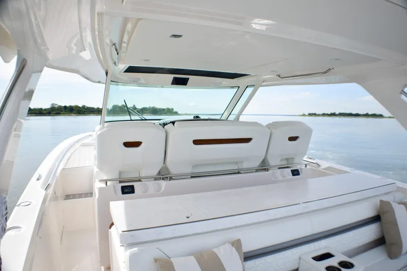 Slide: The Image of 2025 Tiara Yachts 43 LS luxury boat interior with seating, overlooking calm waters. - 45