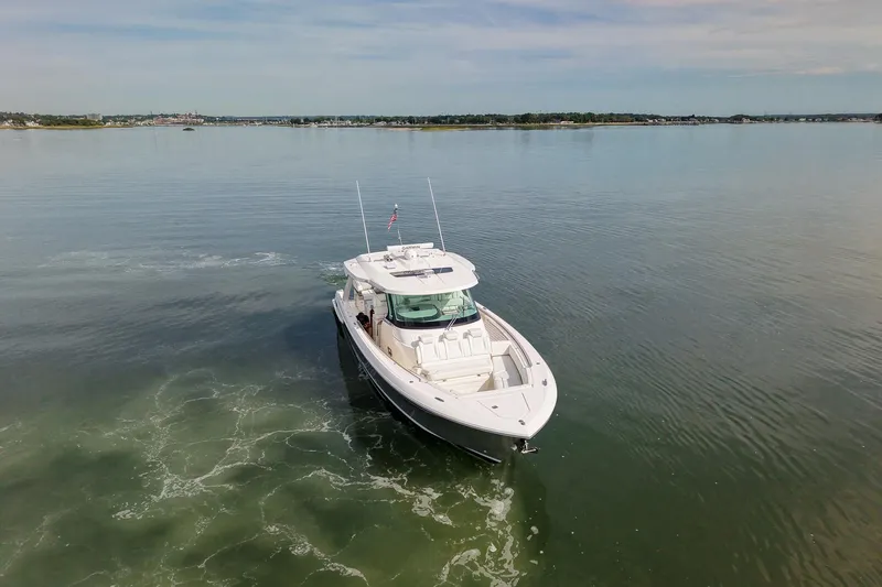 Slide: The Image of 2025 Tiara Yachts 43 LS cruising on calm waters under a clear sky. - 5