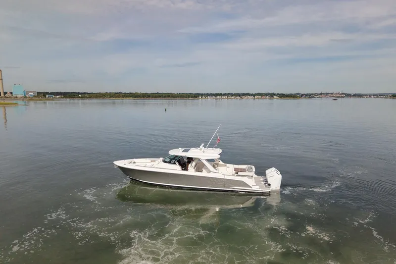 Slide: The Image of 2025 Tiara Yachts 43 LS cruising on calm waters under a clear sky. - 7