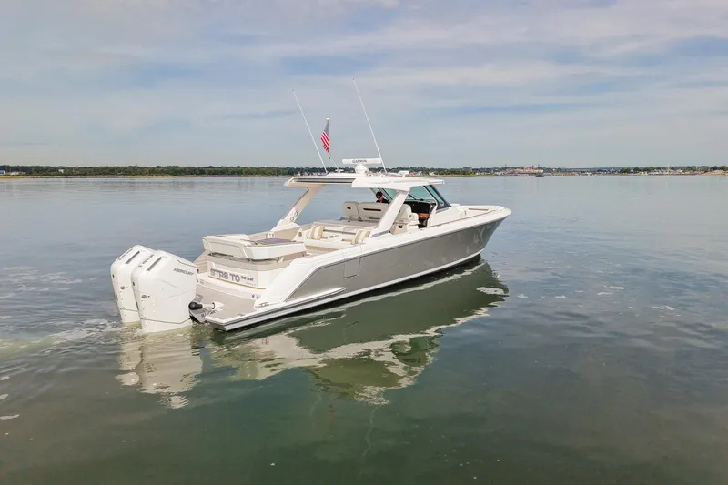 Slide: The Image of 2025 Tiara Yachts 43 LS cruising on calm waters, showcasing sleek design and powerful engines. - 9