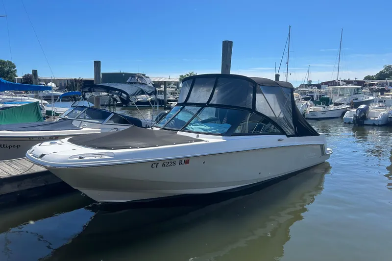 Slide: The Image of 2017 Boston Whaler 230 Vantage boat docked in a marina under clear blue skies. - 1
