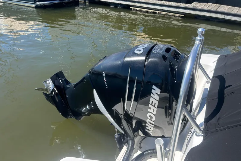 Slide: The Image of Outboard motor on 2017 Boston Whaler 230 Vantage, docked by the water. - 10