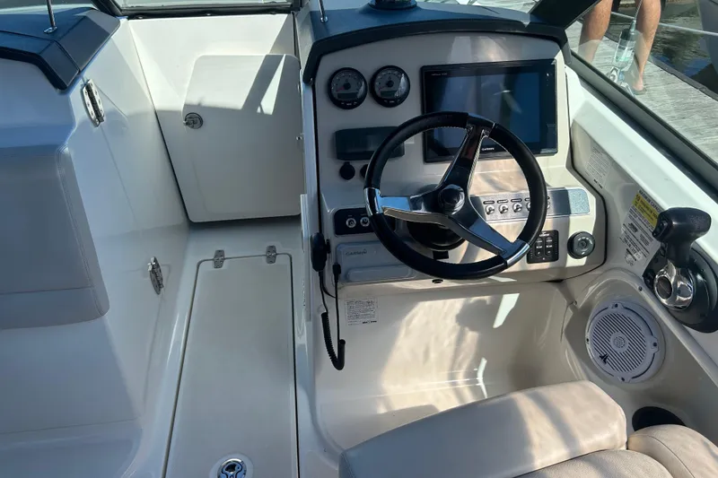 Slide: The Image of 2017 Boston Whaler 230 Vantage boat cockpit with steering wheel and control panel. - 5