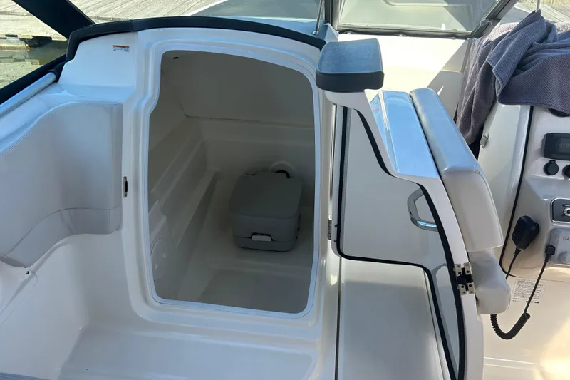 Slide: The Image of 2017 Boston Whaler 230 Vantage interior storage compartment with portable toilet. - 8