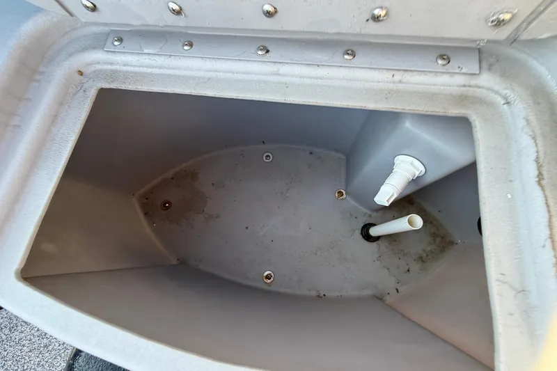 Slide: The Image of Open storage compartment in a 2021 Bennington 20SFi boat, showing interior details. - 15
