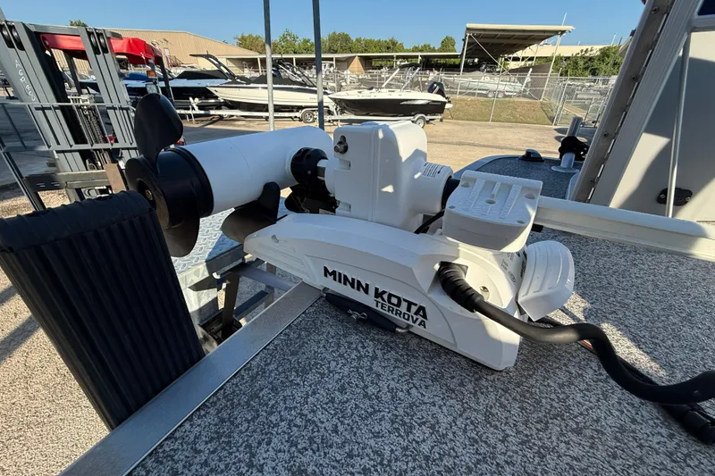 Slide: The Image of Minn Kota Terrova motor on 2021 Bennington 20SFi boat, docked with other boats. - 16