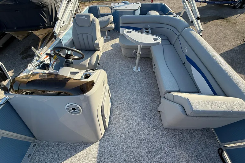 Slide: The Image of 2021 Bennington 20SFi pontoon boat interior with plush seating and steering console. - 17