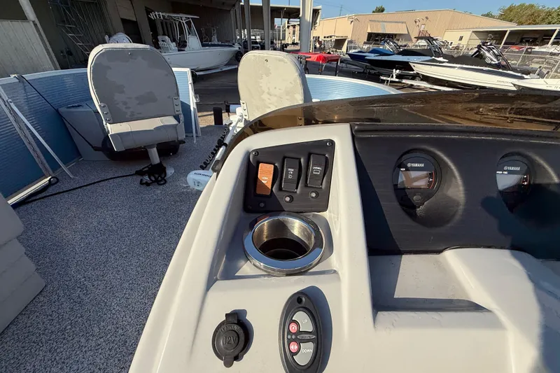 Slide: The Image of 2021 Bennington 20SFi boat dashboard with controls and Yamaha gauges. - 20
