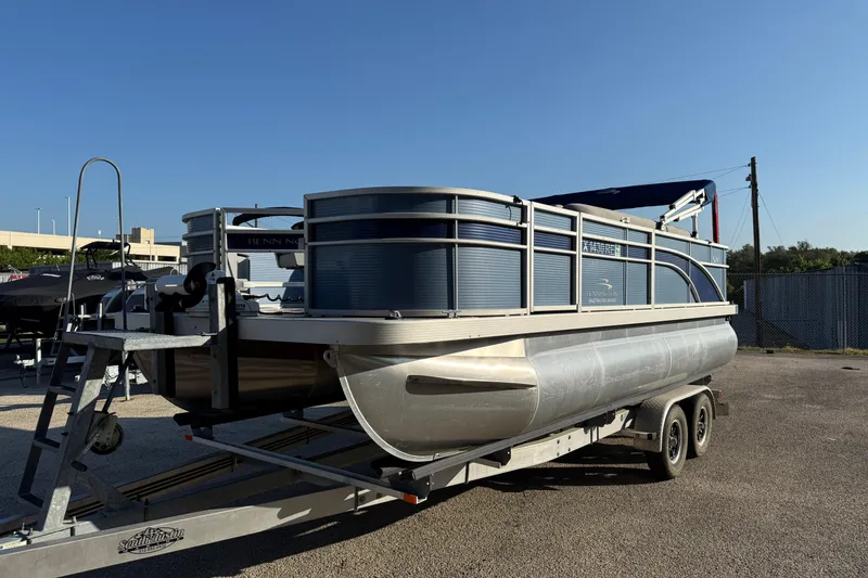 Slide: The Image of 2021 Bennington 20SFi pontoon boat on trailer under clear blue sky. - 22