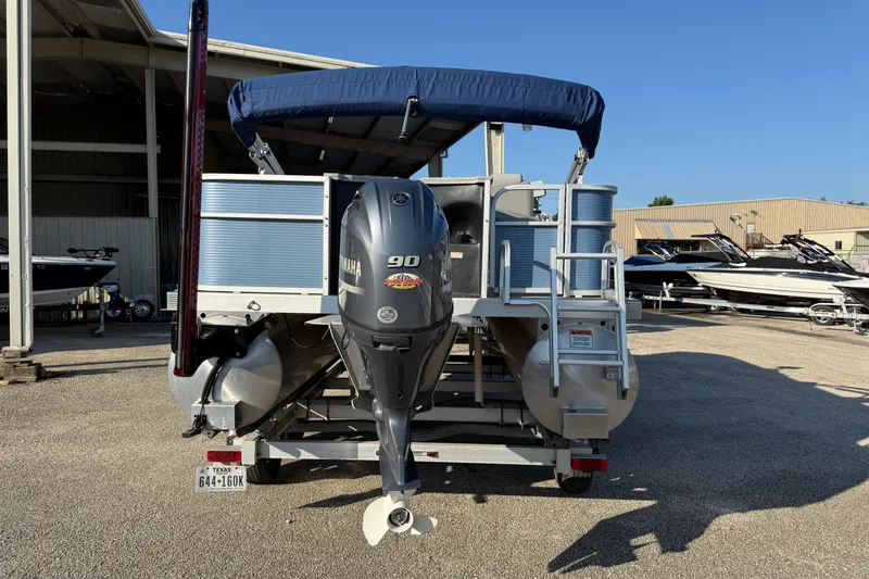 Slide: The Image of 2021 Bennington 20SFi pontoon boat with Yamaha 90 engine, parked outdoors. - 7