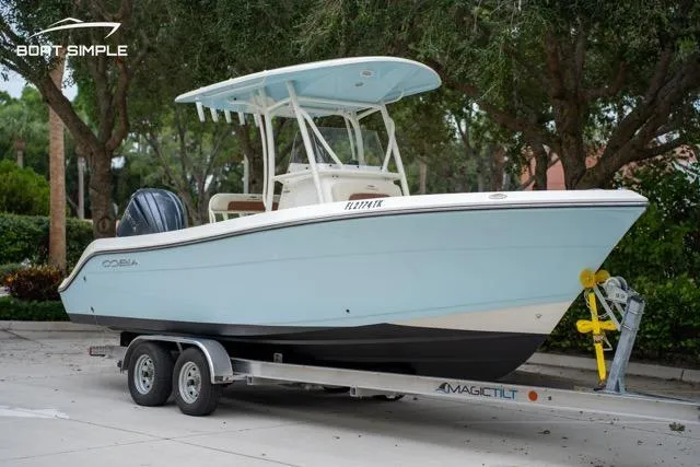 Slide: The Image of 2023 Cobia 240 Center Console boat on trailer, parked outdoors. - 4
