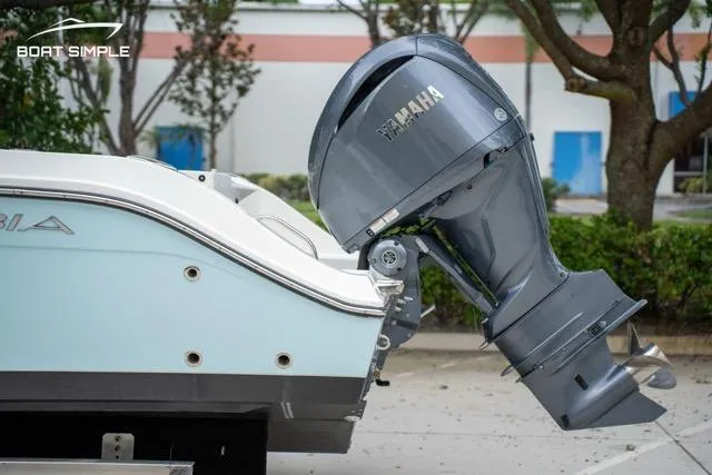 Slide: The Image of 2023 Cobia 240 Center Console with Yamaha outboard motor, parked outdoors. - 8