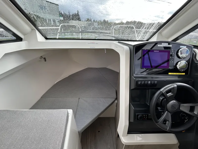 Slide: The Image of 2023 Bayliner Trophy T23 Explorer cabin with modern dashboard and comfortable seating. - 15