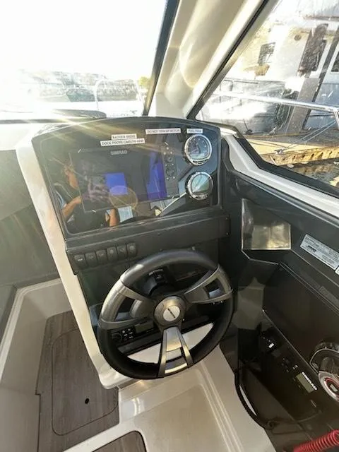 Slide: The Image of 2023 Bayliner Trophy T23 Explorer helm with modern controls and steering wheel. - 4