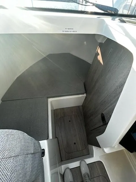 Slide: The Image of 2023 Bayliner Trophy T23 Explorer cabin interior with modern design and wood accents. - 6