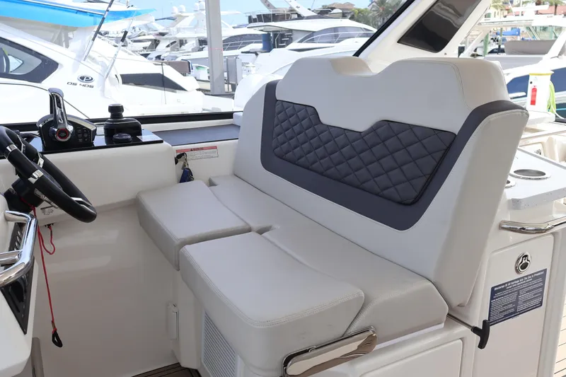 Slide: The Image of 2023 Aquila 36 Sport interior with modern helm and cushioned seating. - 17