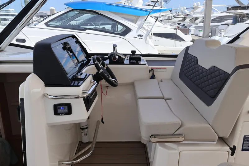 Slide: The Image of 2023 Aquila 36 Sport boat interior with modern helm and seating at marina. - 18