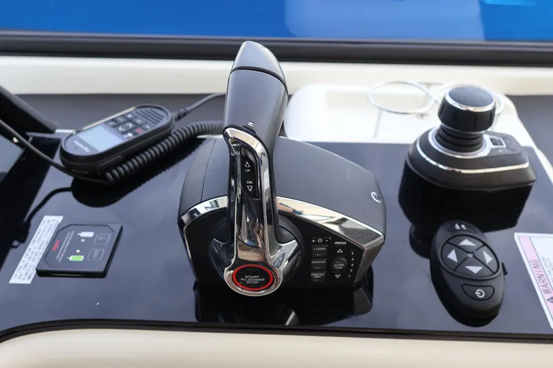 Slide: The Image of Control panel of 2023 Aquila 36 Sport boat with throttle and joystick. - 20