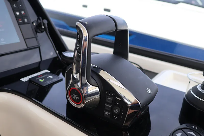 Slide: The Image of Control panel of 2023 Aquila 36 Sport boat, featuring modern throttle and navigation controls. - 21