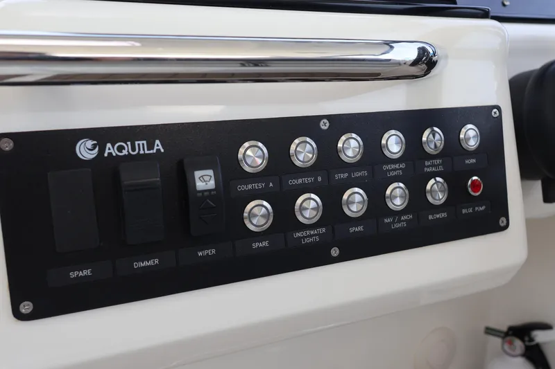 Slide: The Image of Control panel of 2023 Aquila 36 Sport boat with various switches and buttons. - 23