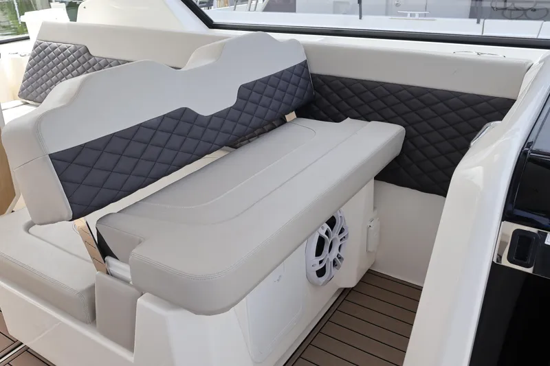 Slide: The Image of 2023 Aquila 36 Sport interior with quilted seating and integrated speaker system. - 24