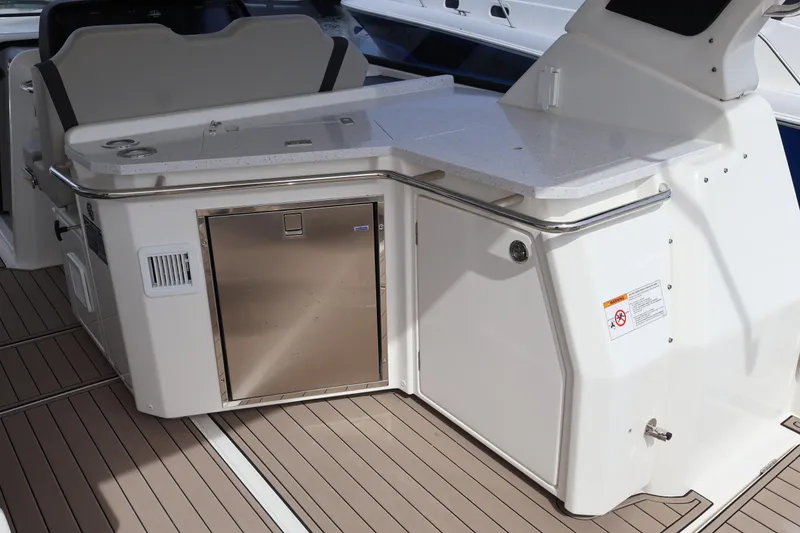 Slide: The Image of 2023 Aquila 36 Sport yacht interior with sleek kitchenette and stainless steel appliances. - 28