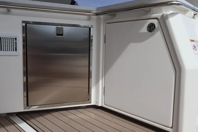 Slide: The Image of 2023 Aquila 36 Sport boat interior with stainless steel door and white paneling. - 29