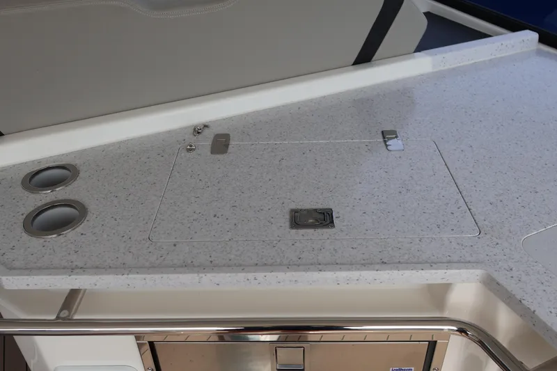 Slide: The Image of 2023 Aquila 36 Sport boat interior with sleek countertop and built-in cup holders. - 32