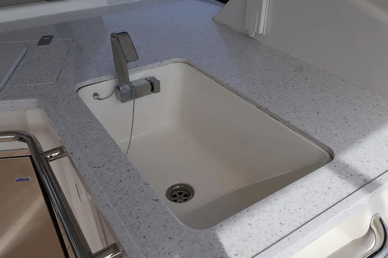 Slide: The Image of Modern kitchen sink on 2023 Aquila 36 Sport boat with sleek countertop design. - 33