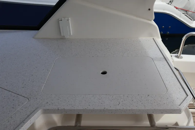 Slide: The Image of 2023 Aquila 36 Sport boat deck with speckled countertop and built-in storage. - 34