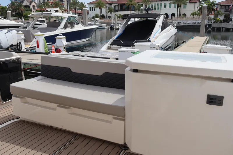 Slide: The Image of 2023 Aquila 36 Sport yacht interior with seating and marina view. - 37