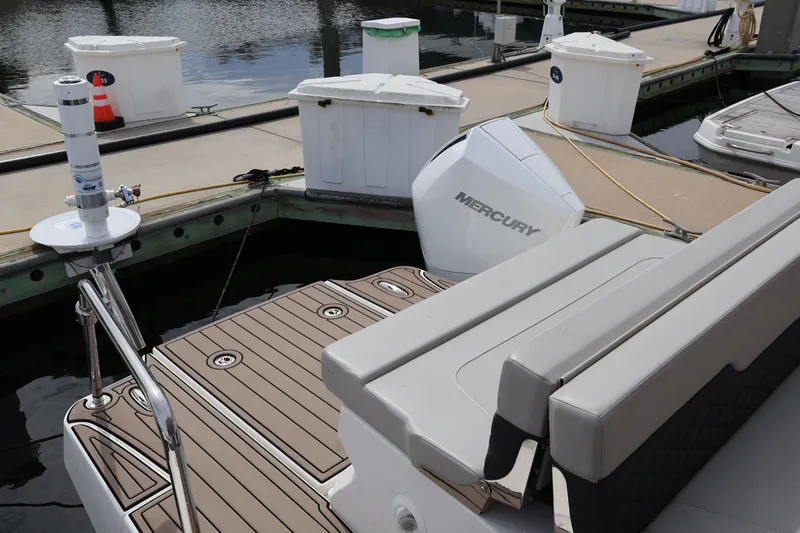 Slide: The Image of 2023 Aquila 36 Sport boat docked with Mercury engine visible. - 38
