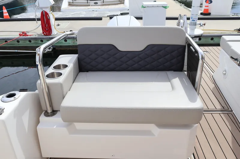 Slide: The Image of Luxury seating on 2023 Aquila 36 Sport boat with cup holders, docked at marina. - 40