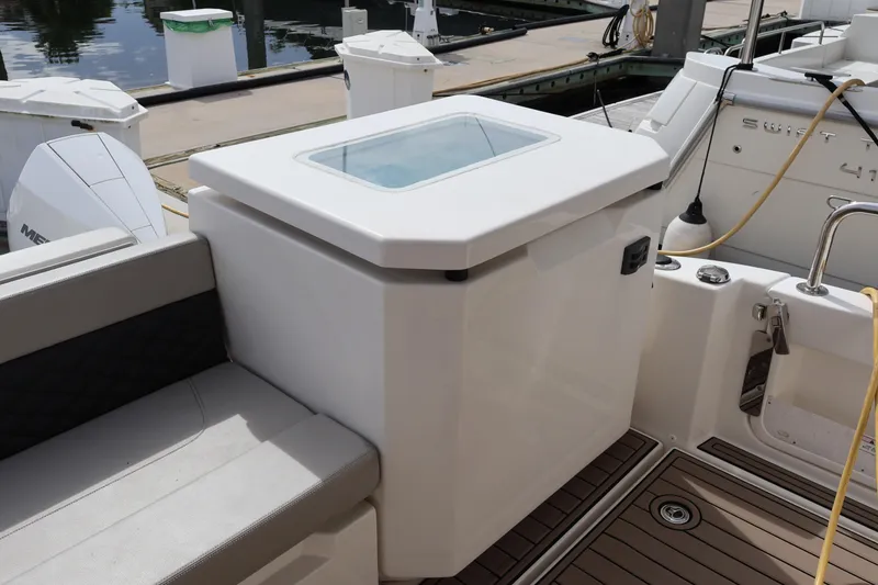 Slide: The Image of 2023 Aquila 36 Sport boat interior with seating and storage compartment. - 41