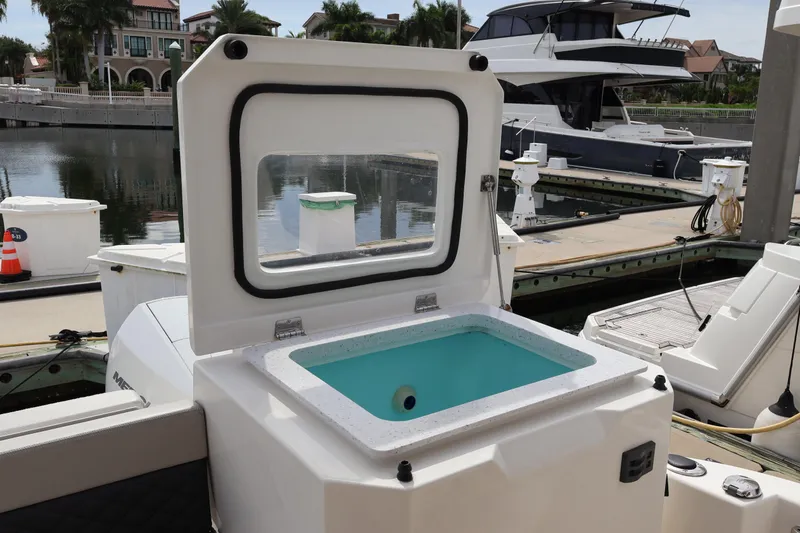 Slide: The Image of 2023 Aquila 36 Sport boat with open storage compartment at marina dock. - 42